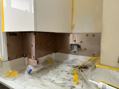 Bronze mirror glass splashback corner install, London kitchen