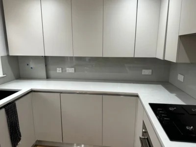 Grey glass splashback in modern London kitchen