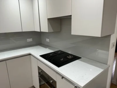 Grey glass splashback behind gas hob, London kitchen