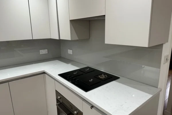 Grey glass splashback behind gas hob, London kitchen