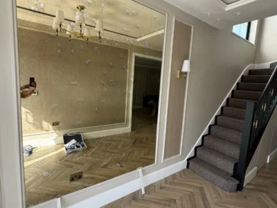 Oversized antiqued wall mirror London hallway glazing