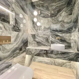 Marble bathroom with frameless wall mirror, London