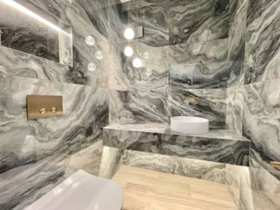 Marble bathroom with frameless wall mirror, London