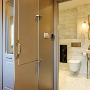 Bathroom mirror panels beside marble WC, London