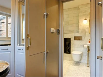 Bathroom mirror panels beside marble WC, London