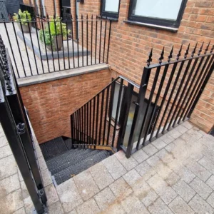 Black metal railings basement lightwell London property