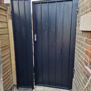 Black timber-effect metal side gates London property