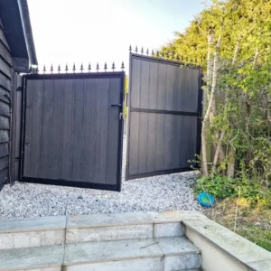 Black timber-clad metal driveway gates London property