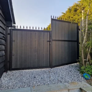 Black timber-clad metal driveway gates London garden