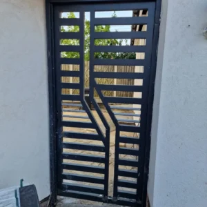 Black slatted metal side gate London property