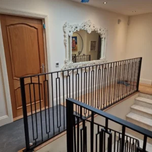 Black metal stair balustrade London hallway renovation