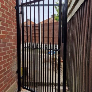 Black metal pedestrian side gate, London