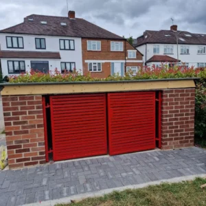 Red roller garage doors on brick garage, London