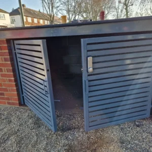 Grey louvred metal bin store enclosure, London