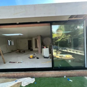 Black aluminium sliding doors during London extension build