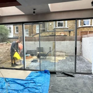 Black aluminium sliding doors in London garden extension