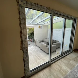 Black aluminium sliding doors in London dining room extension