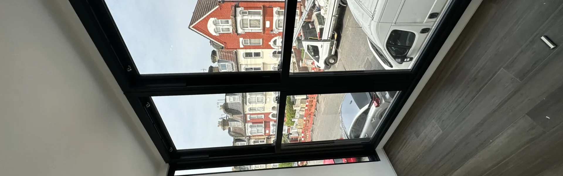 Black-framed flat rooflight over London loft conversion