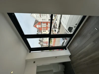 Black-framed flat rooflight over London loft conversion