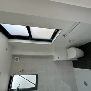 Black aluminium opening rooflight in London bathroom ceiling