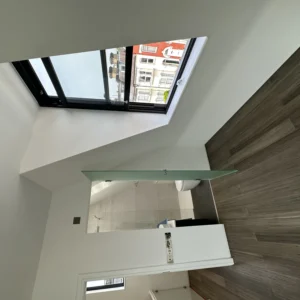 Black aluminium opening rooflight in modern London bathroom