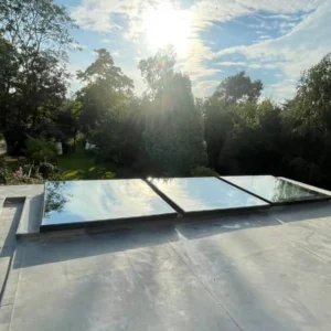 Three glass rooflights on London flat-roof extension at sunrise