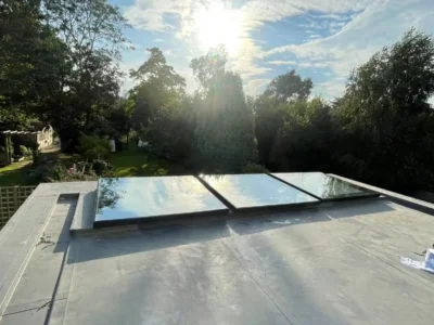 Three glass rooflights on London flat-roof extension at sunrise
