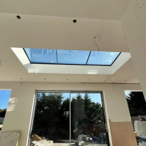 Flat rooflight over aluminium sliding doors in London extension