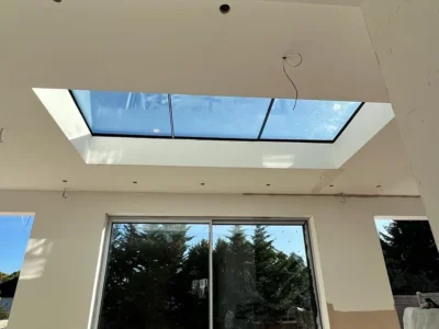 Flat rooflight over aluminium sliding doors in London extension
