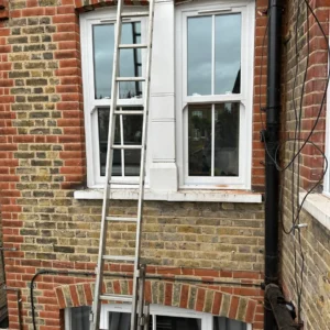 White timber sash bay window on London brick house