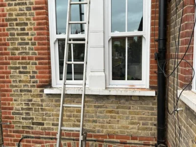 White timber sash bay window on London brick house