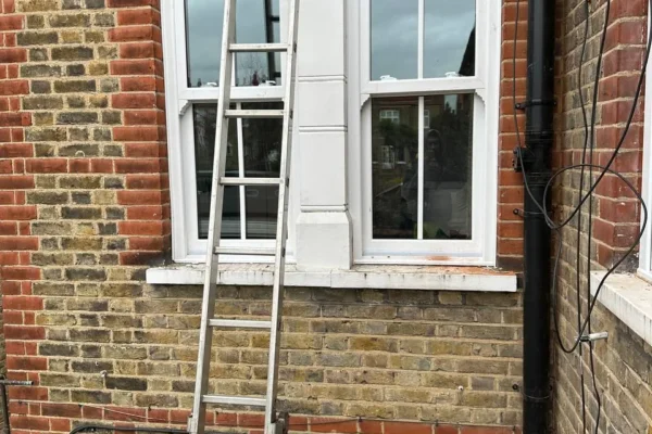 White timber sash bay window on London brick house