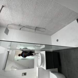 Walk-in glass shower screen in tiled London ensuite