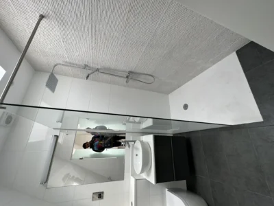 Walk-in glass shower screen in tiled London ensuite