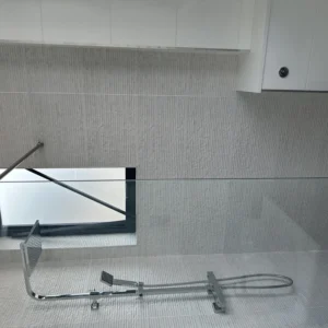 Glass shower screen and window in tiled London bathroom