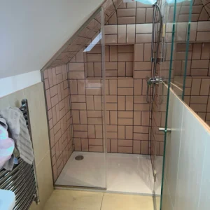 Frameless glass shower screen in London loft bathroom
