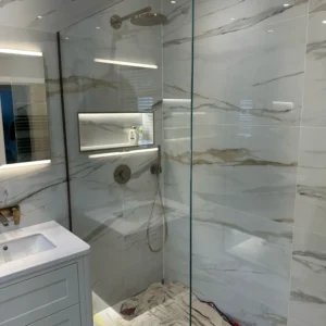 Frameless glass shower screen in London marble bathroom