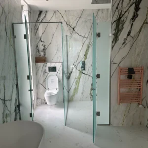 Frameless glass shower screens marble London bathroom