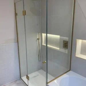 Brass-framed hinged glass shower enclosure London bathroom