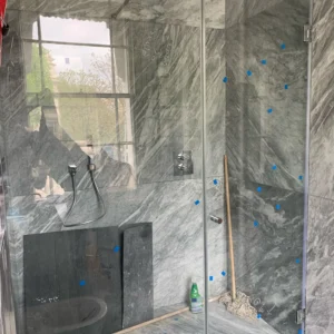 Frameless glass shower screen grey marble London bathroom