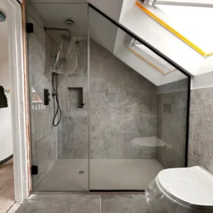 Black-framed sliding glass shower screen London loft bathroom