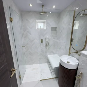 Frameless glass shower screen in tiled London bathroom