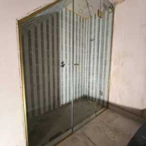 Bespoke glass shower screen with brass trim, London