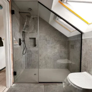 Frameless glass shower screen in loft bathroom, London
