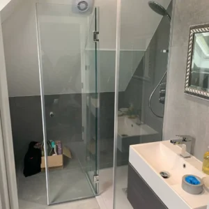 Compact frameless glass shower screen, London loft bathroom