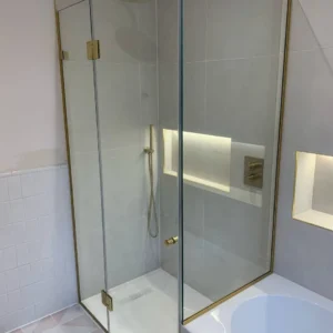 Frameless glass shower screen with brass fittings, London