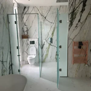 Pivoting frosted glass shower screens, London marble bathroom