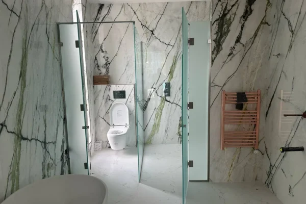 Pivoting frosted glass shower screens, London marble bathroom