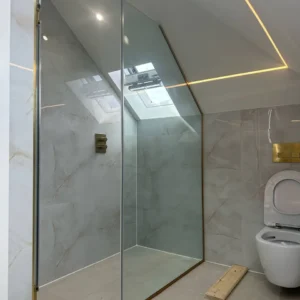 Angled frameless glass shower screen, London loft bathroom