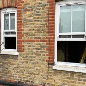 White uPVC sash windows on London yellow-brick house